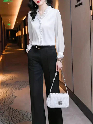 Woman in an elegant summer blouse with soft long sleeves.