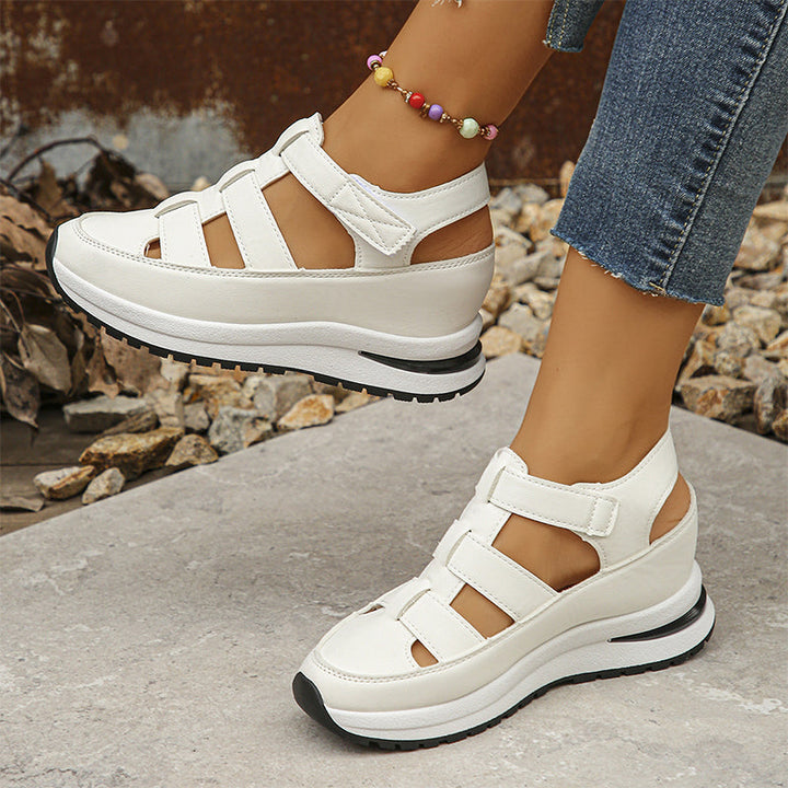 Thick sole white sneakers on rocky background