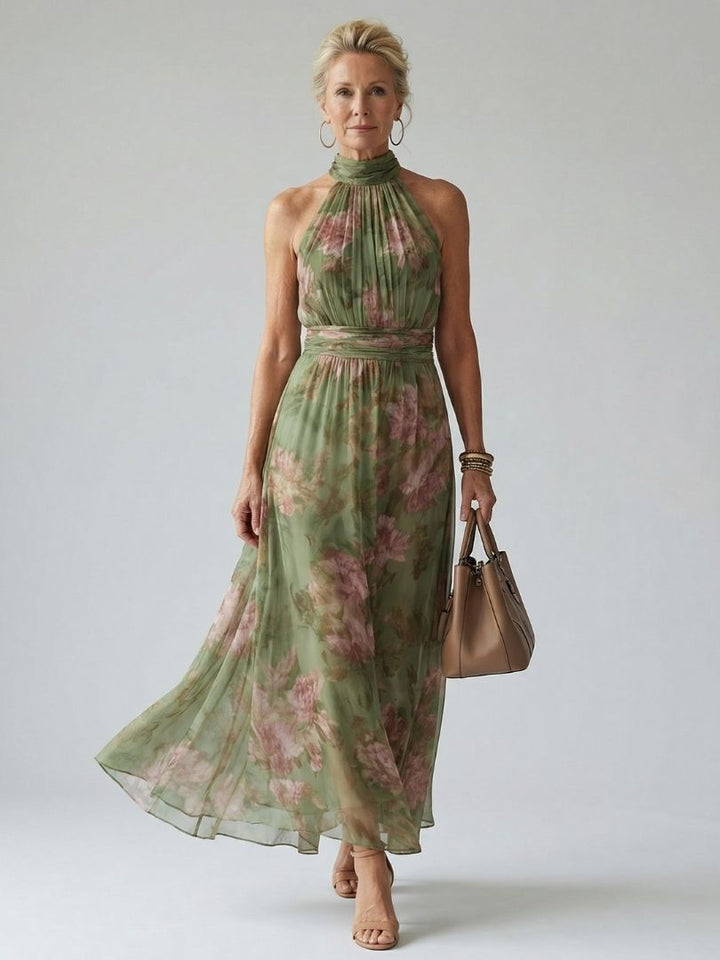 Female wearing a striped maxi dress on a plain background