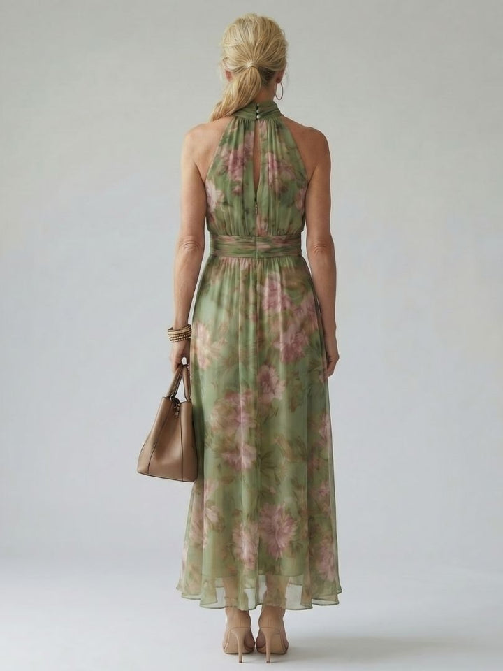 Sleeveless striped maxi dress shown on a woman in studio setting, back view