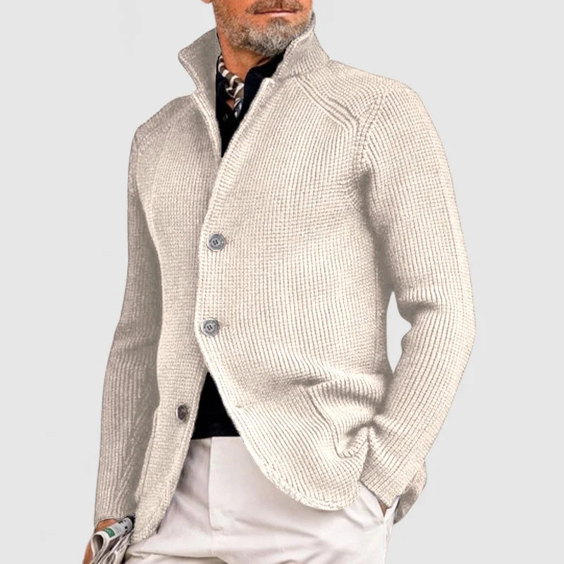  Man presenting a lightweight summer suit with a refined casual look on a plain background.