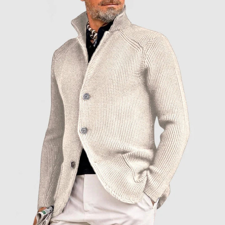  Man presenting a lightweight summer suit with a refined casual look on a plain background.