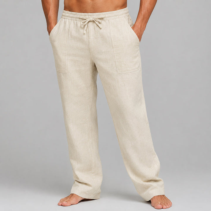 Model wearing relaxed men’s linen blend pants on a plain background.