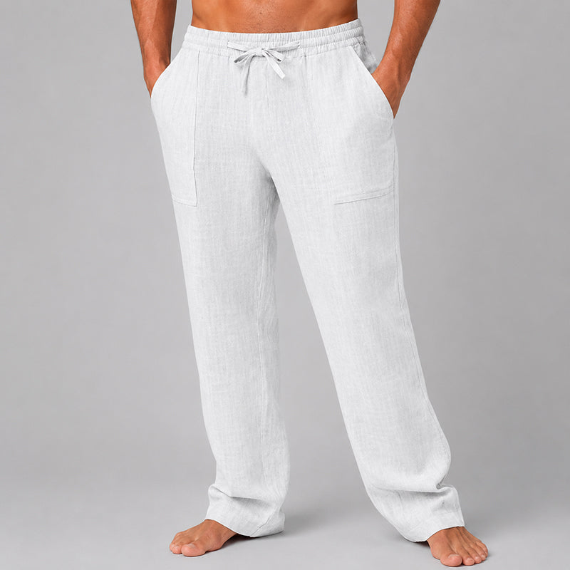  Model displaying relaxed fit men’s pants on a plain background.