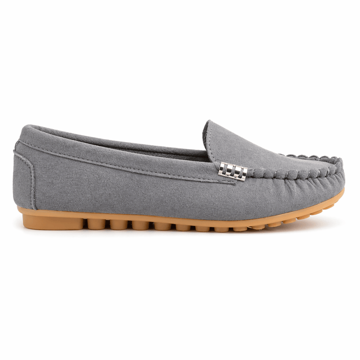 Fashionable loafers with a timeless silhouette on a plain background.