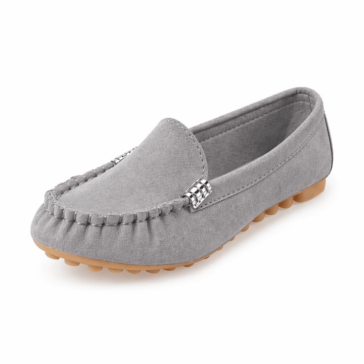 Classic slip-on shoes on a plain background.