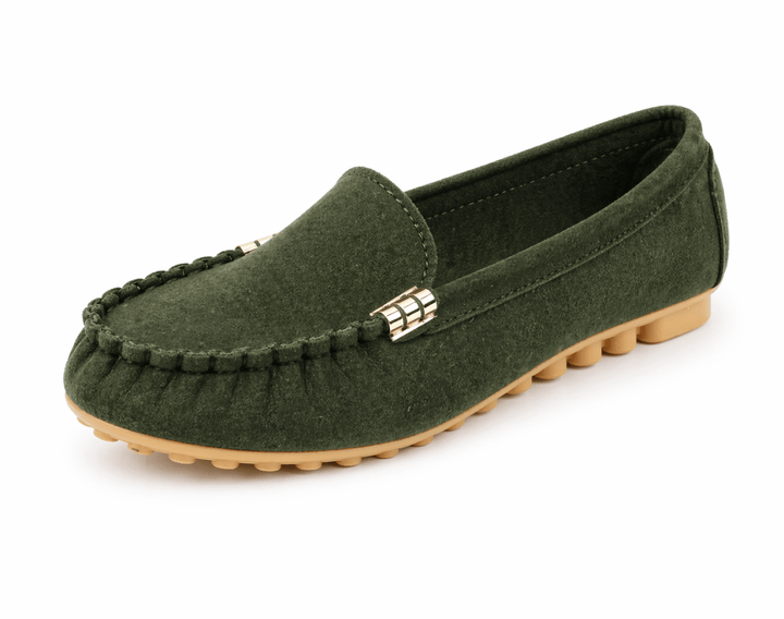 Slip-on loafers paired with simple styling on a plain background.