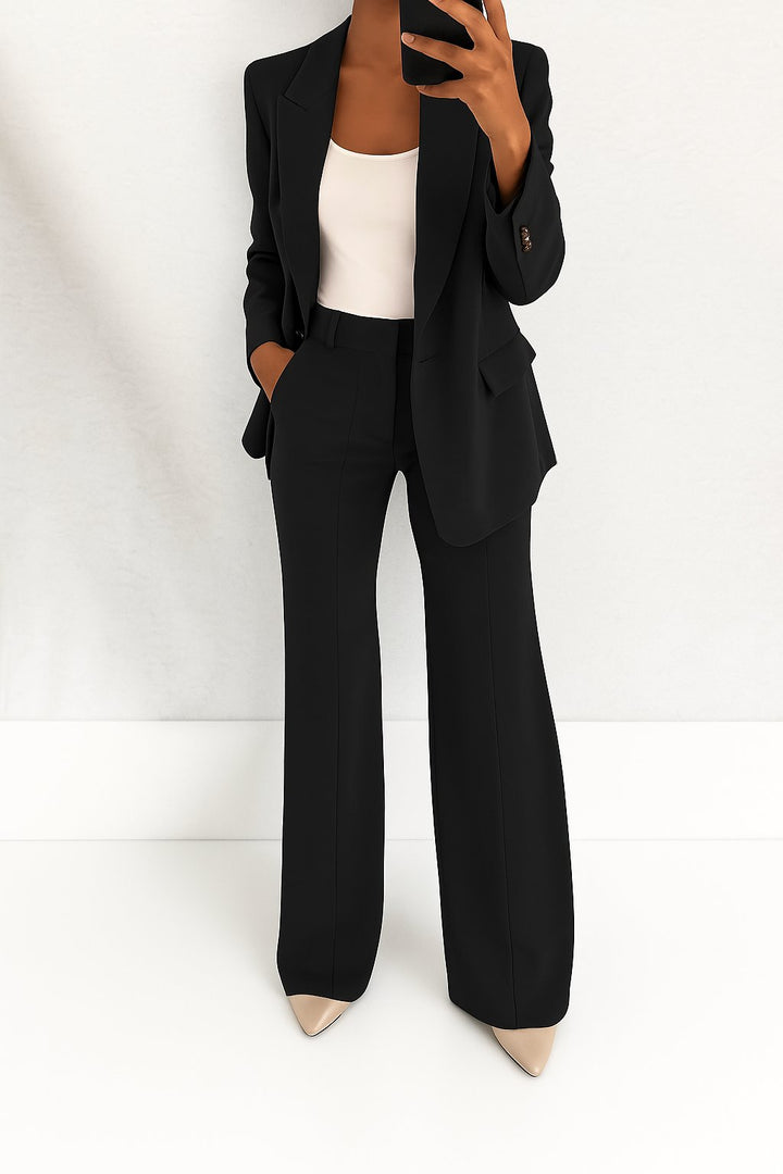 Woman styled in a clean oversized two-piece blazer outfit on a plain background.
