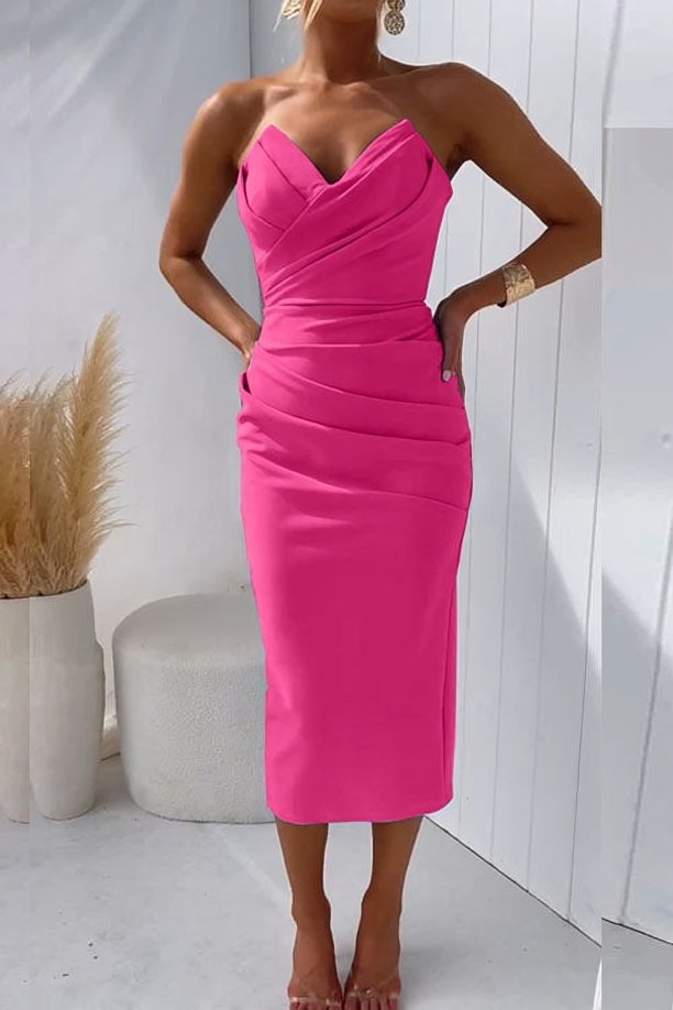 Woman wearing a chic midi dress with gathered detailing and a streamlined fit on a plain background.