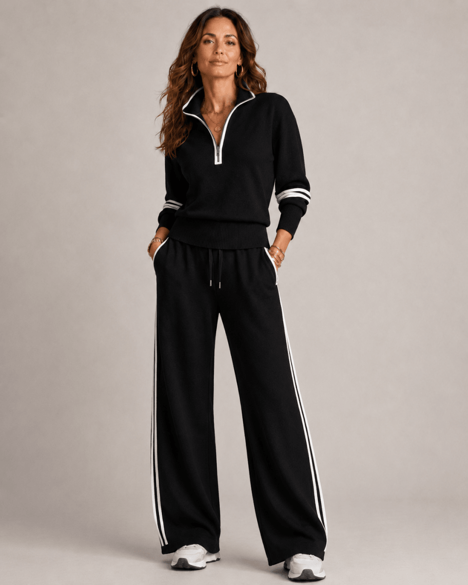  Woman displaying a casual two-piece look with a zip-up top on a plain background.