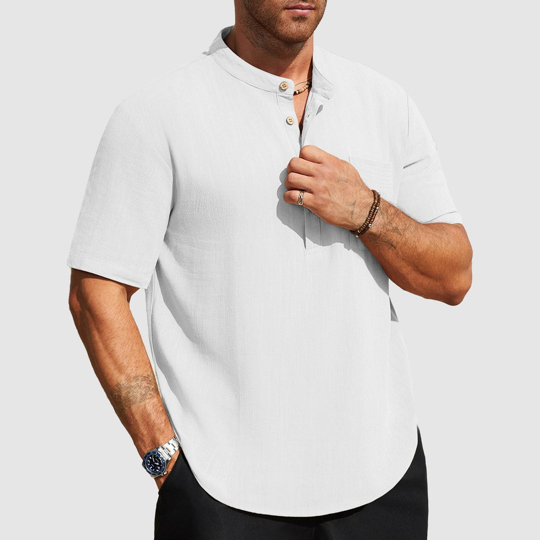  Man in a button front casual shirt shown on a plain background.