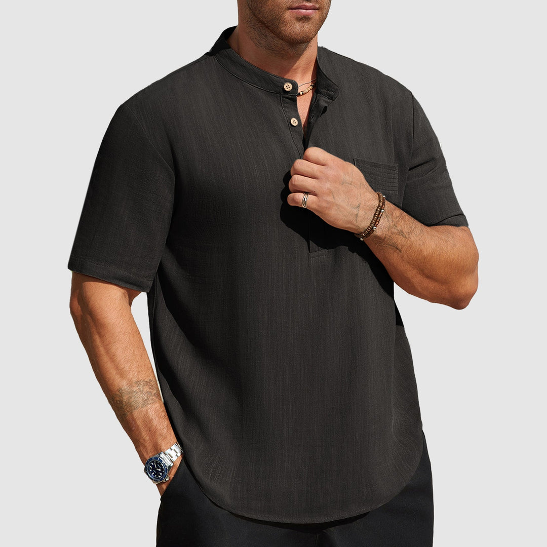  Male model wearing a lightweight vacation style shirt on a plain background.