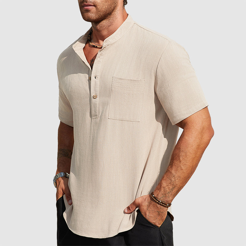  Male model in a relaxed resort inspired shirt on a plain background.