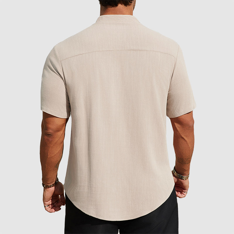  Man wearing a casual button shirt with an easy fit on a plain background.