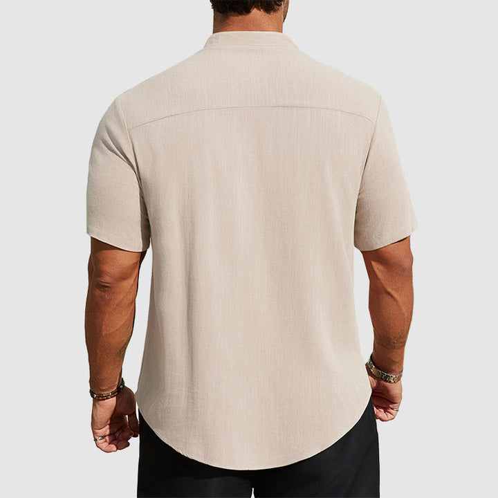  Man wearing a casual button shirt with an easy fit on a plain background.