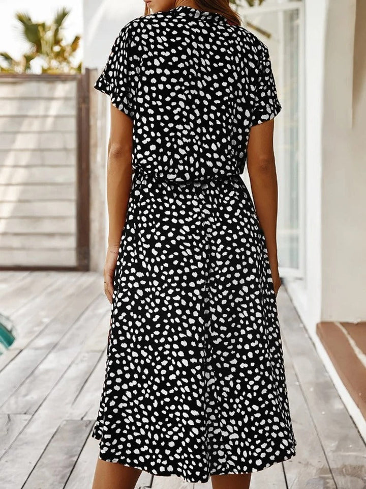 Model back pose in printed dotted dress