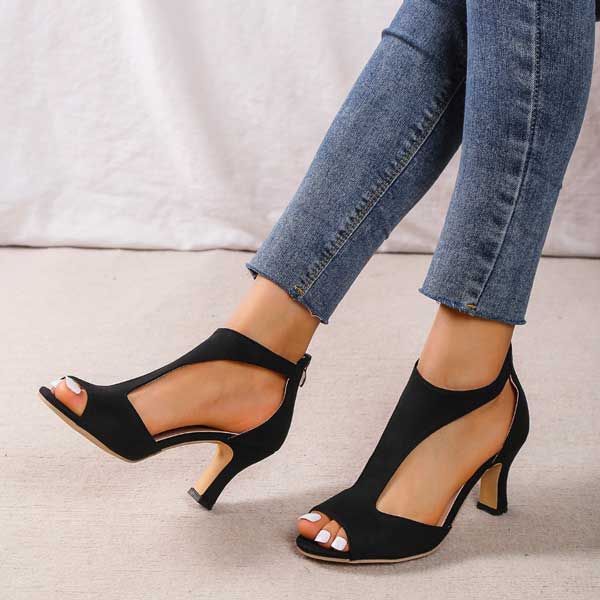 Foot model relaxed pose wearing sandals neutral plain background setup