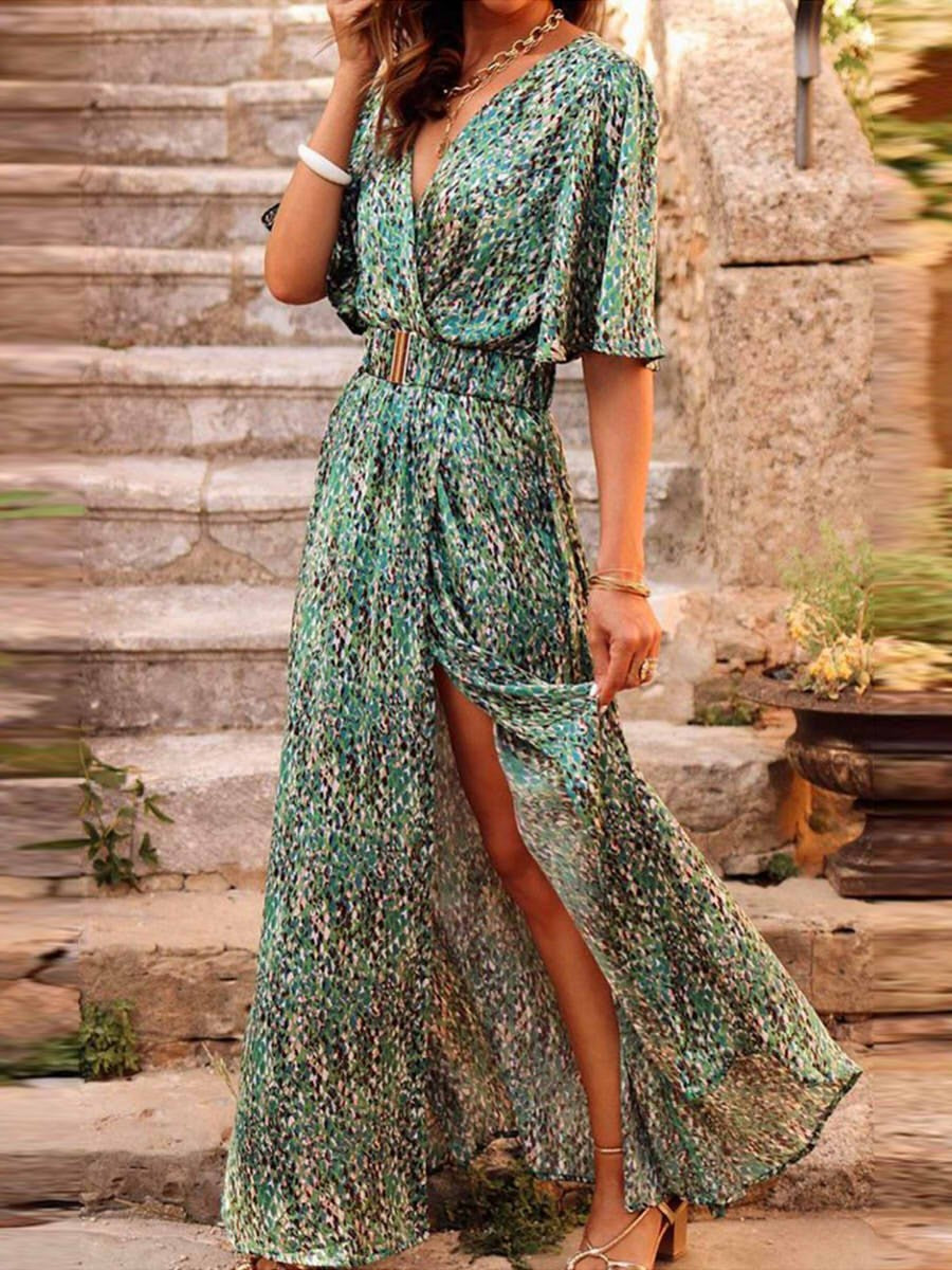 Woman model wearing a floral wrap maxi dress against a staircase background.