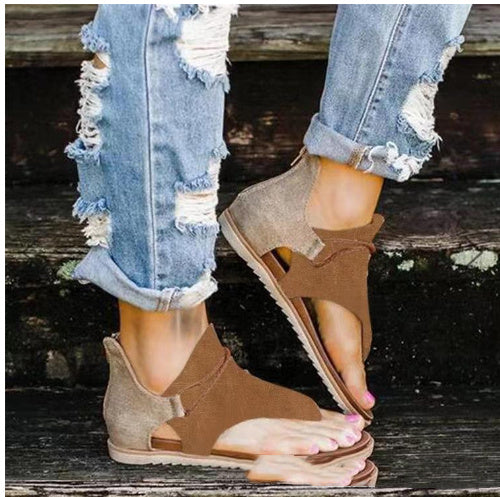 Foot model showing sandal straps from front on beige background.