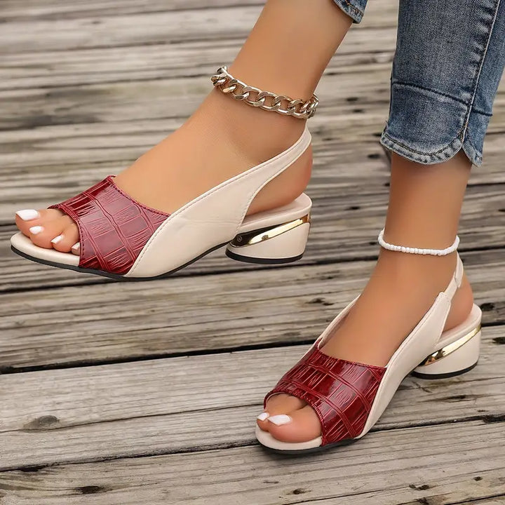  Female model showcasing open-toe sandals with adjustable straps on a plain background.
