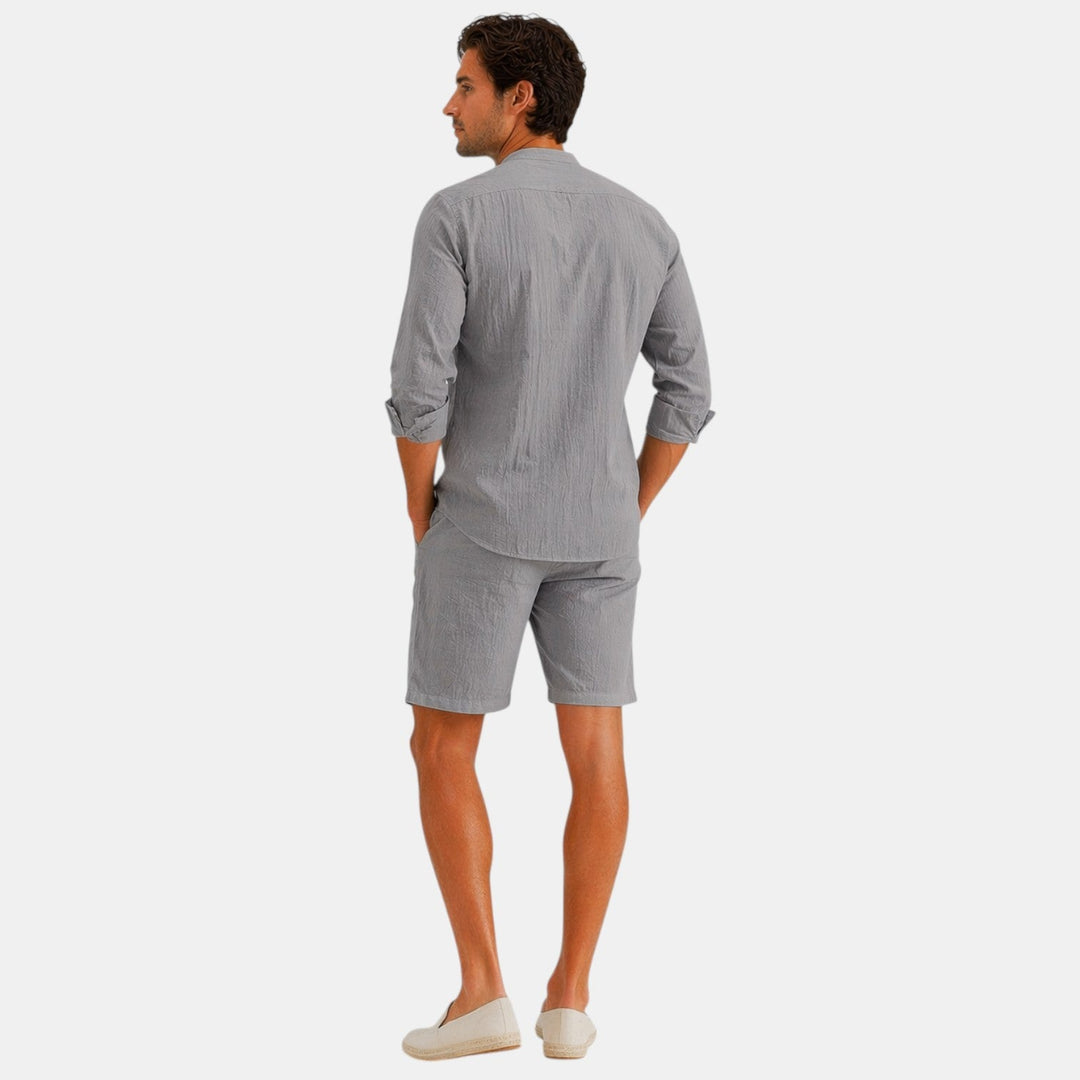  Male model wearing a breathable looking shirt and pants set against a plain background.
