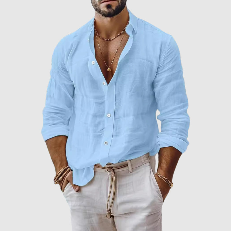 Woman wearing a relaxed button-up shirt against a plain background.