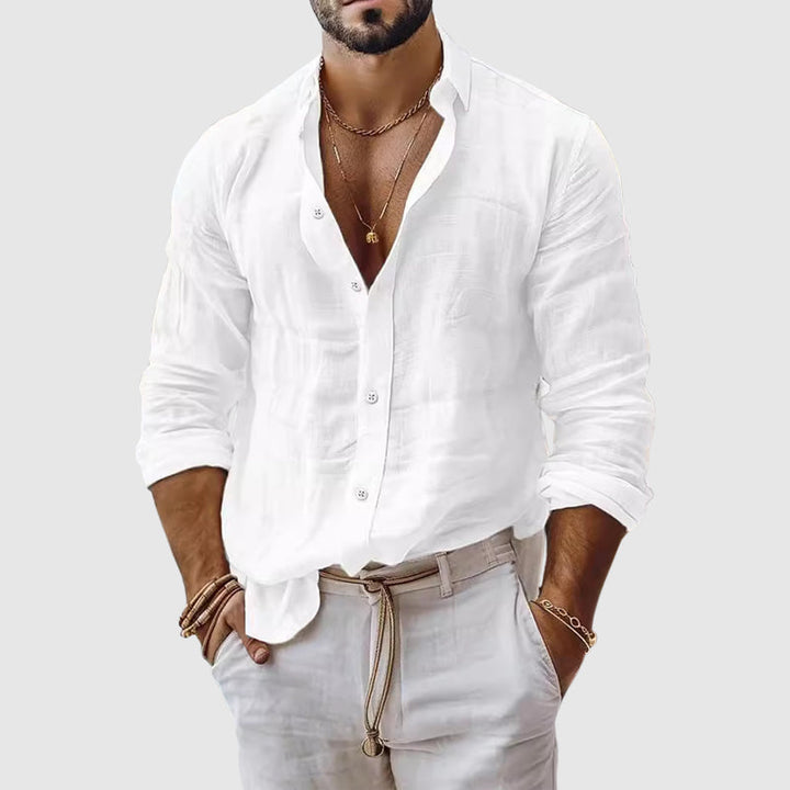  Female model wearing a breezy button-up shirt with a clean open neckline.