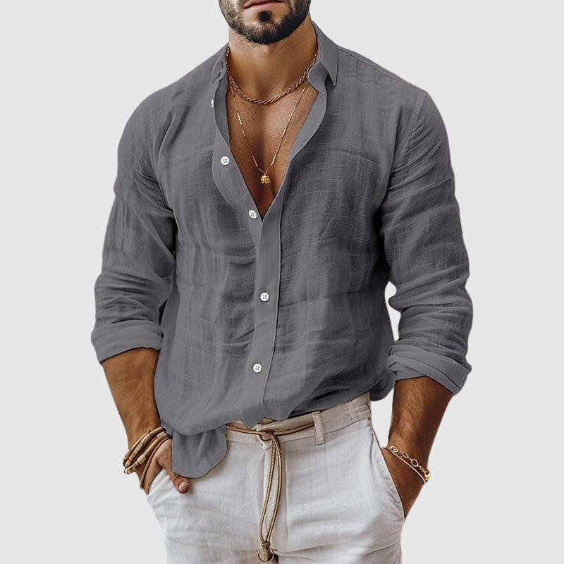  Female model wearing a casual button-up top with an airy silhouette.