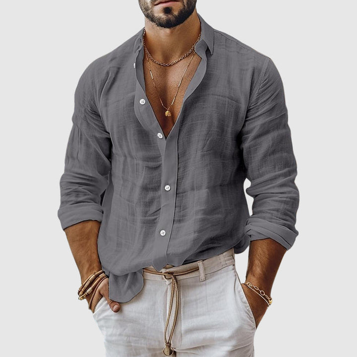  Female model wearing a casual button-up top with an airy silhouette.