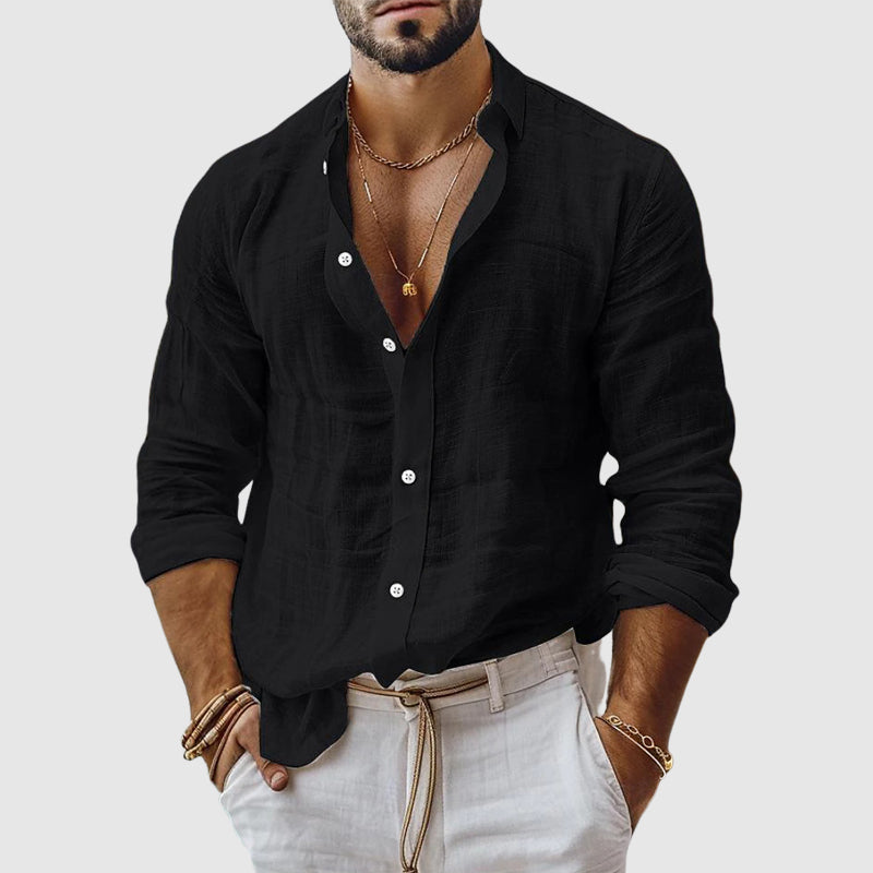  Woman styling a relaxed collared shirt against a plain background.