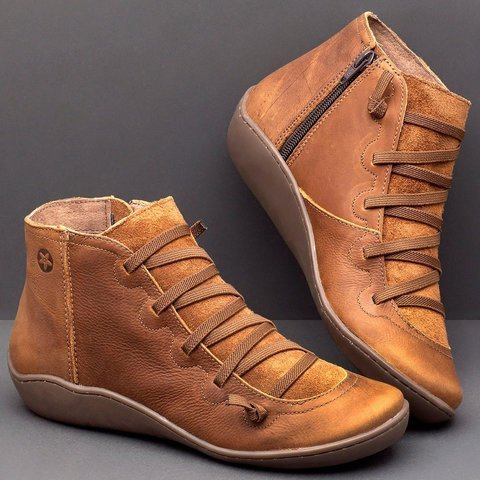 Pair of brown high-top shoes on a gray background