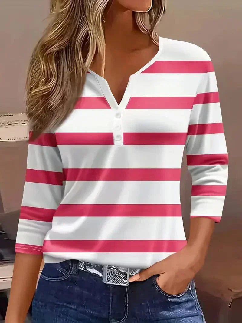 Female model styling a soft nautical stripe shirt on a plain background.
