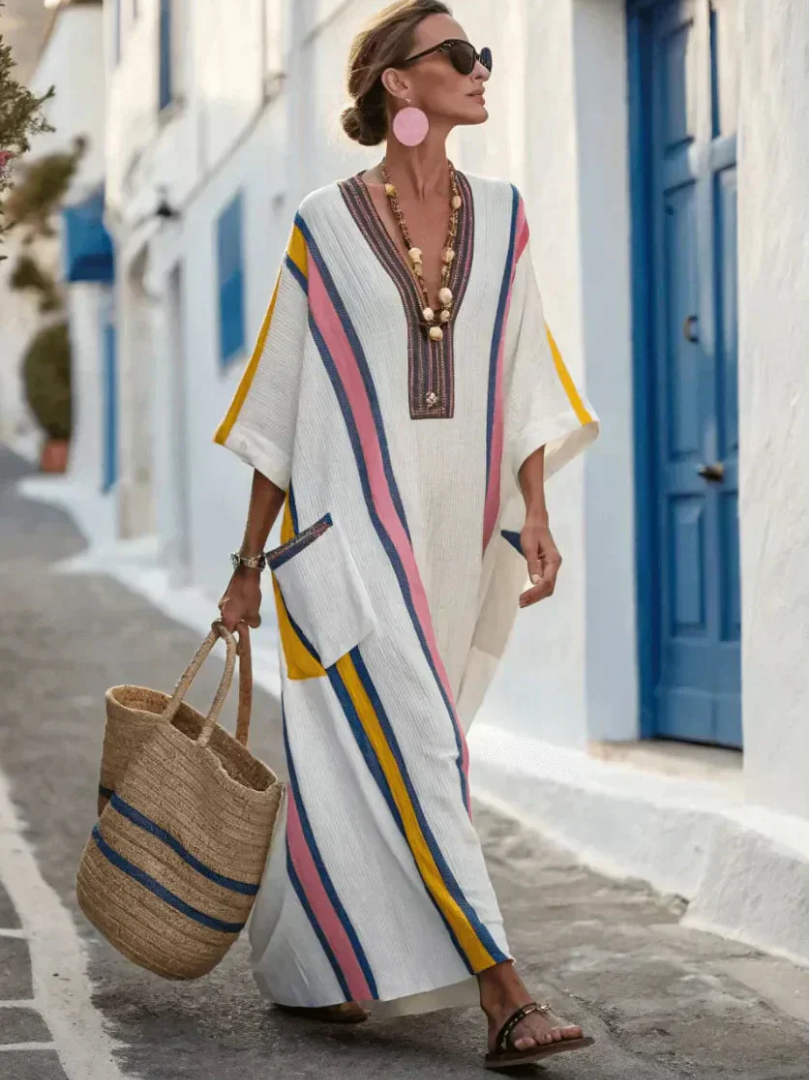 Casual women’s maxi dress with pockets on a plain background.