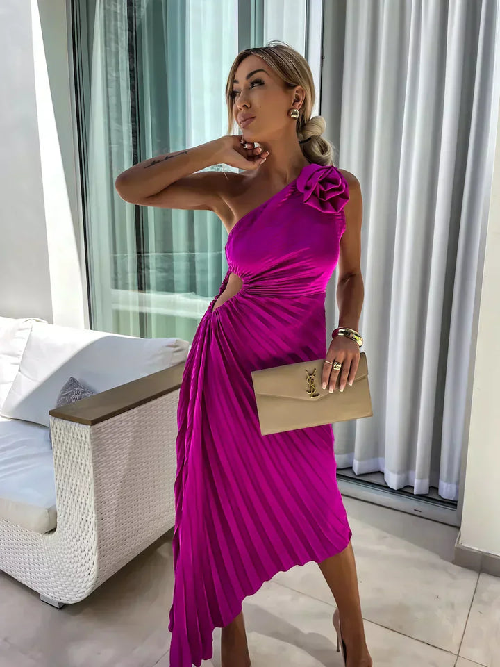 Woman model wearing a semi-formal one shoulder dress with pleated movement and structured fit on a plain background.