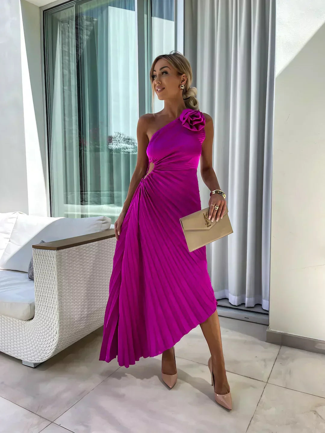 Model in a refined A-line midi dress with one shoulder neckline and rose accent on a clean background.