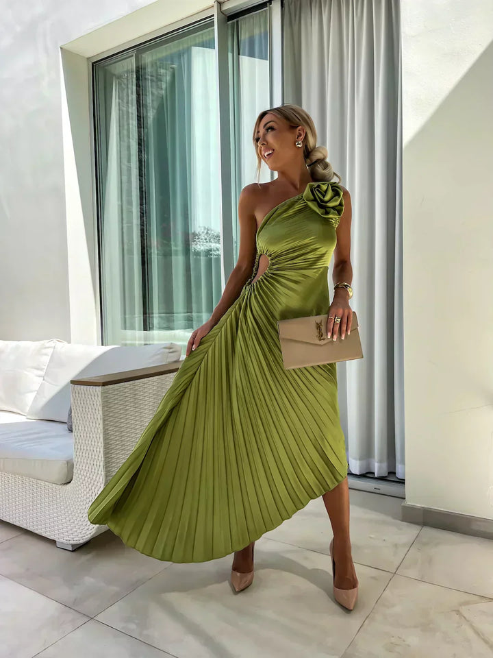 Model in an asymmetrical one shoulder A-line midi dress with soft structured shape on a clean background.