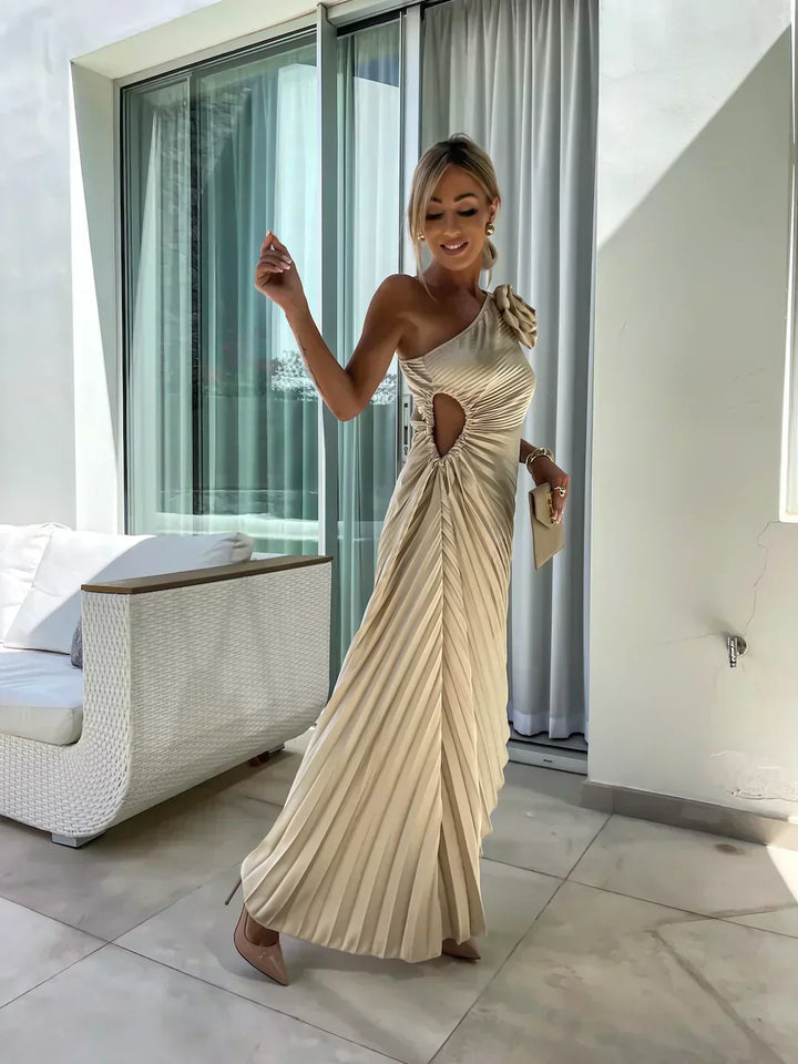 Woman model showcasing an elegant semi-formal dress with one shoulder cut and A-line silhouette on a clean background.