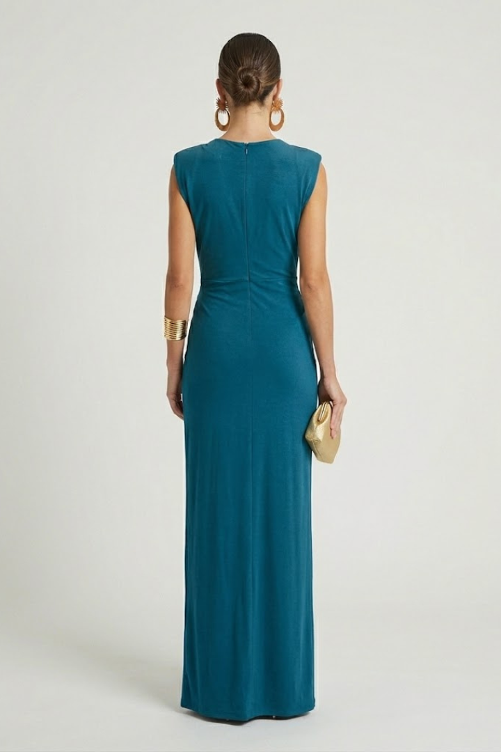 Female model wearing textured sleeveless maxi dress in back view.