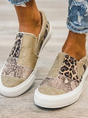 Beige walking shoes paired with distressed denim jeans