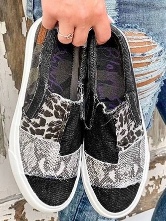 Model displayed holding black animal shoes 