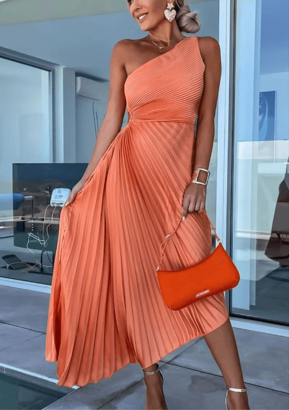 Woman wearing pleated maxi dress in cozy crystal living room background