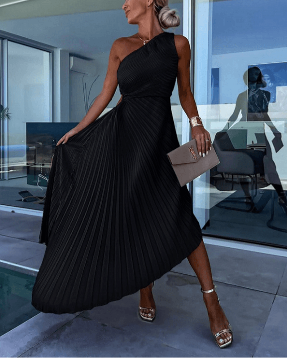 Female model in a maxi dress featuring a one shoulder design and graceful pleated finish.
