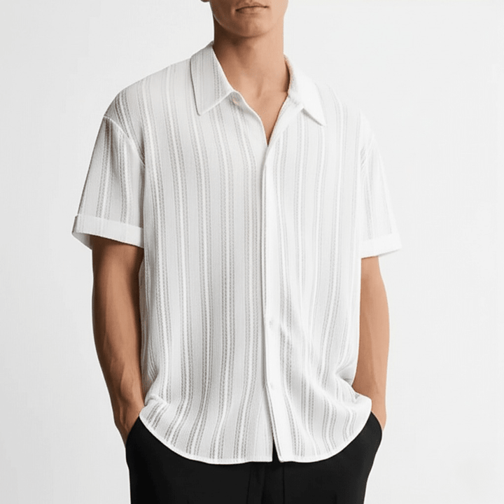  Male model wearing a collared short sleeve shirt on a plain background.