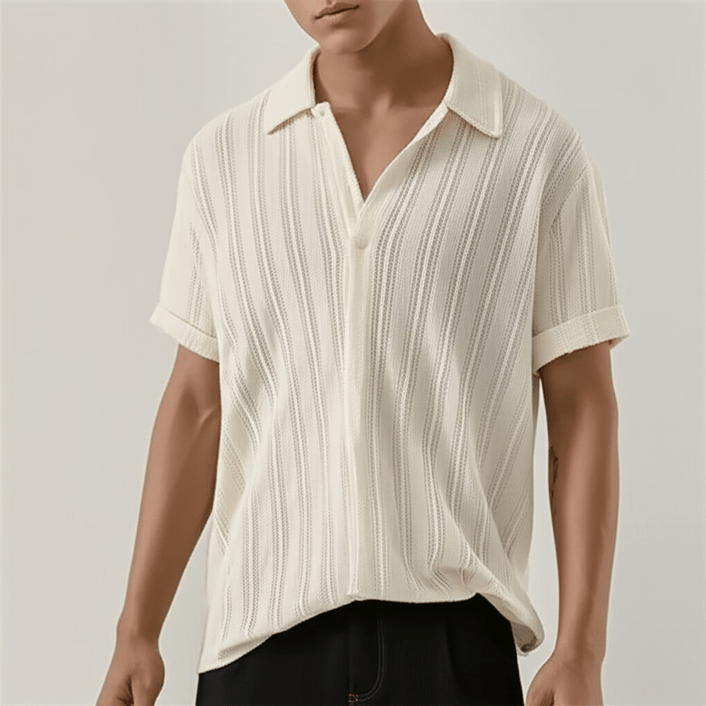  Man showcasing a button front shirt with a classic collar on a plain background. 