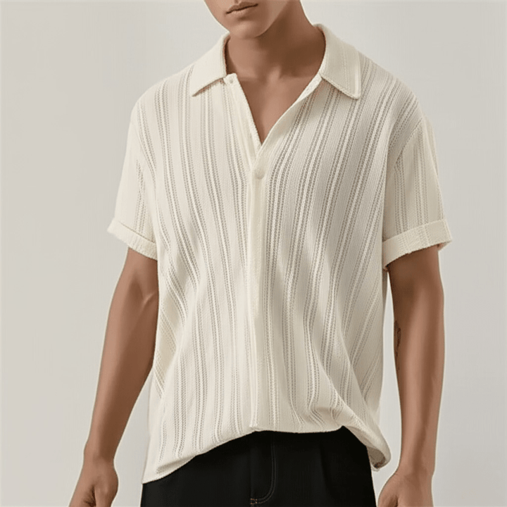  Man showcasing a button front shirt with a classic collar on a plain background. 