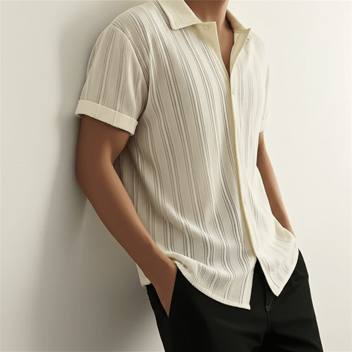  Male model wearing a smart casual short sleeve shirt on a plain background.