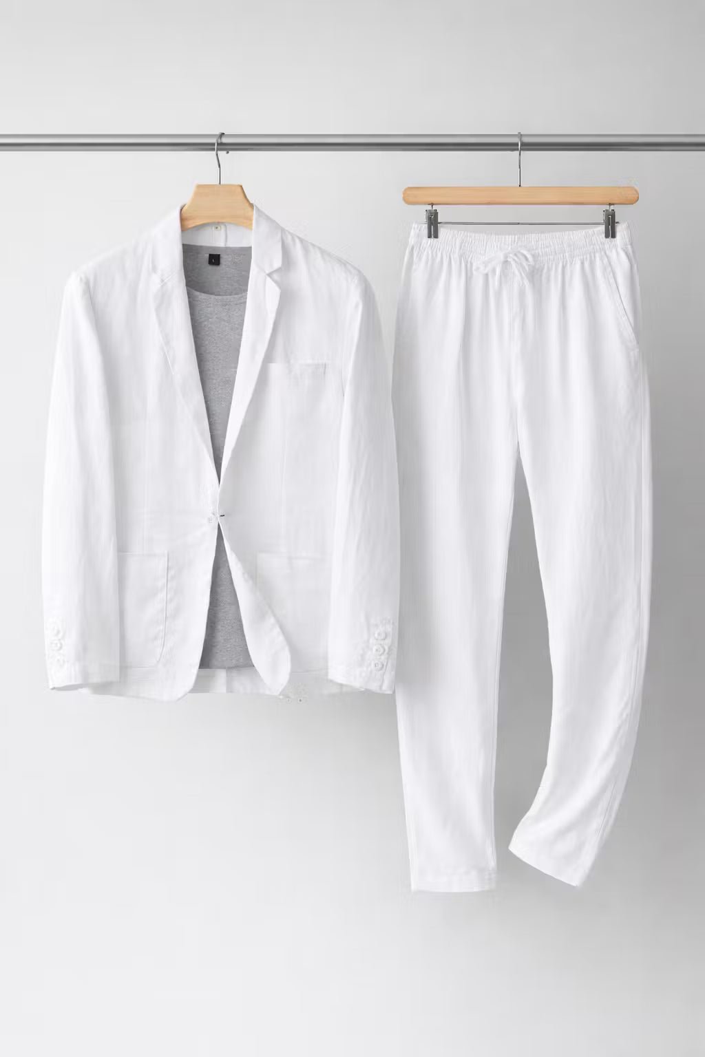 A classic blazer and matching trousers on a plain background.