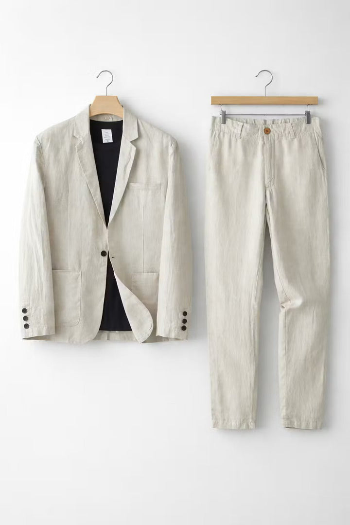 A coordinated blazer and trouser outfit on a plain background.