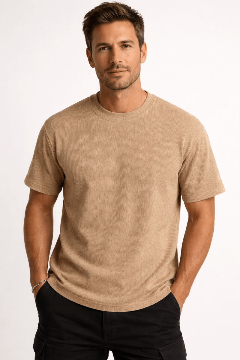 Male model wearing a classic crew neck T-shirt on a plain background.