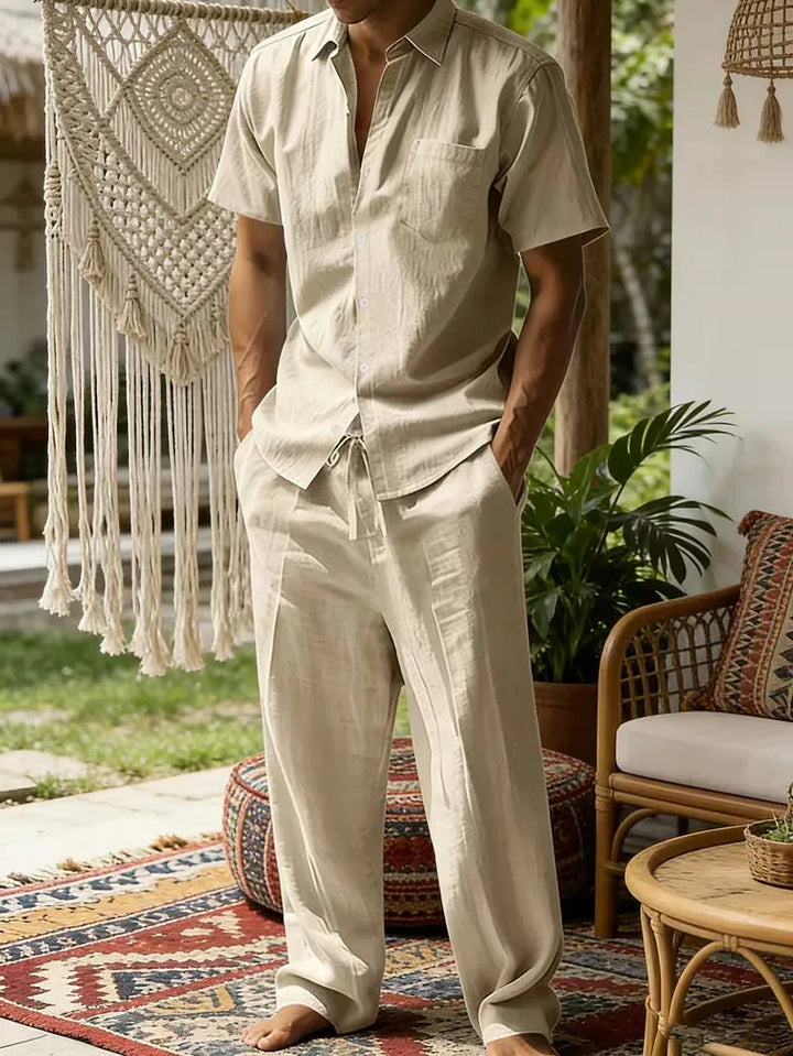  Man showcasing a refined casual outfit on a plain background.